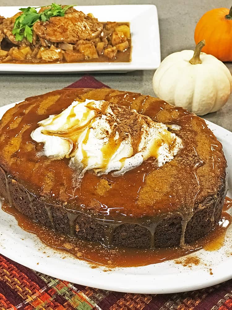 Pumpkin cake topped with whipped cream and caramel sauce