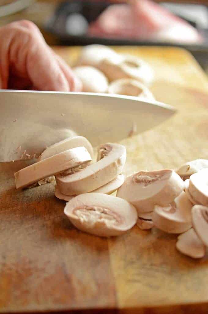 slicing mushrooms for savory pork chops recipe.