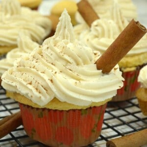 A cupcake with yellow frosting and cinnamon stick