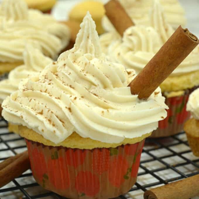 A cupcake with yellow frosting and cinnamon stick