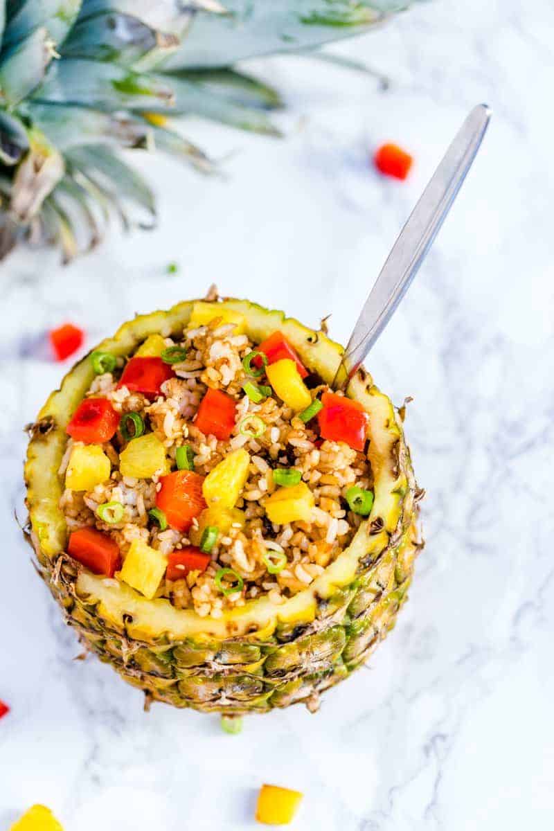 A pineapple filled with fried rice.
