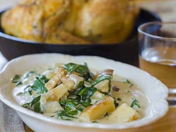 Serving dish of creqmed spinach and parsnips