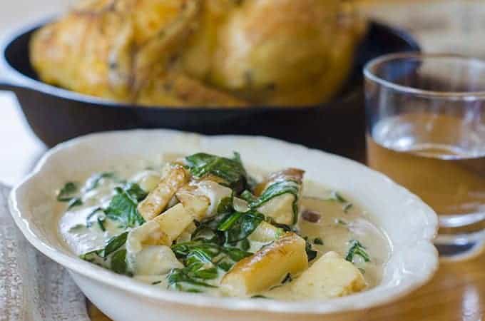 Serving dish of creqmed spinach and parsnips