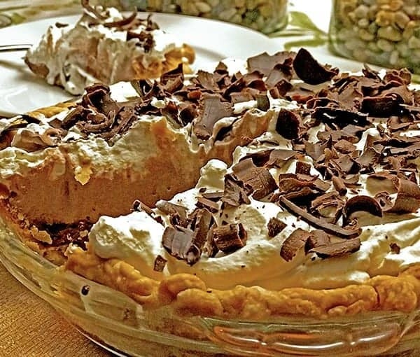 Chocolate cream pie with slice of same behind