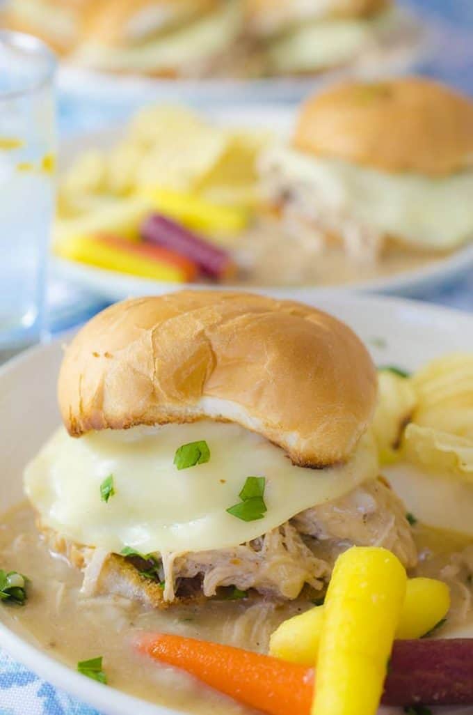 2 plates of rolls filled with creamy turkey and cheese with vegetables