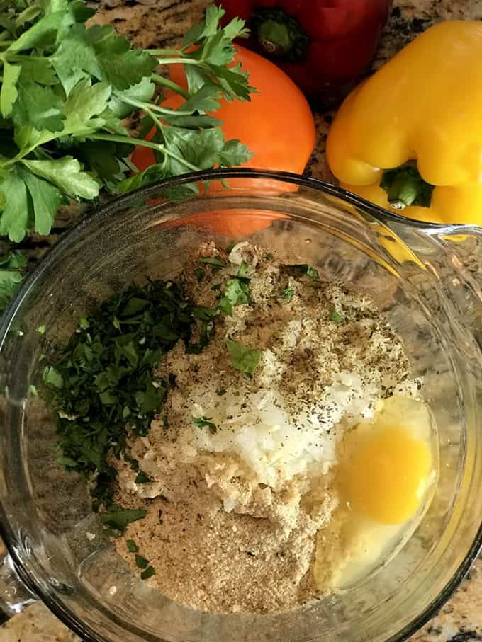 Mixing bowl full of ingredients for making a stuffed peppers recipe.