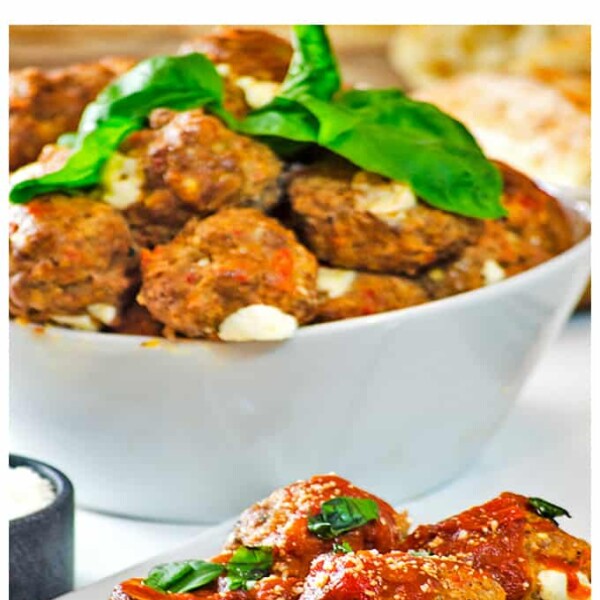 Serving bowl of meatballs with dish of meat balls in front