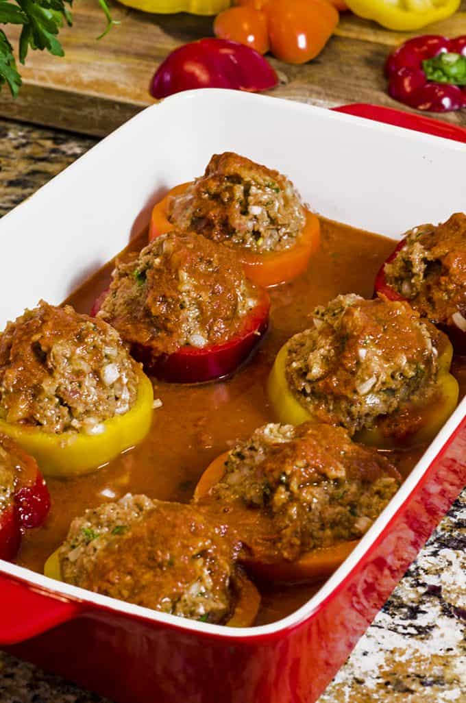 A plate of food, with Stuffed peppers and Sausage