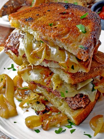 Close up of cut, stacked, grilled patty melt
