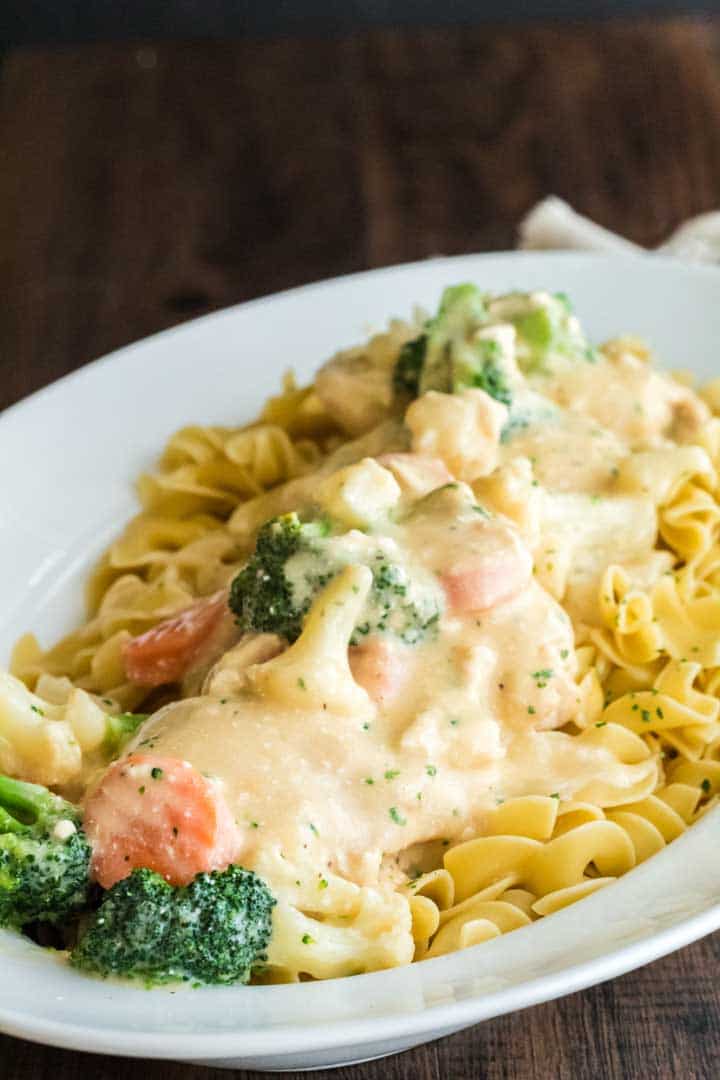A plate of food with broccoli, Chicken, and egg noodles