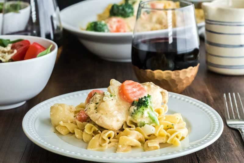 Slow cooker creamy chicken can be made for just a couple of dollars per serving. A Plate of slow cooker chicken breast with egg noodles