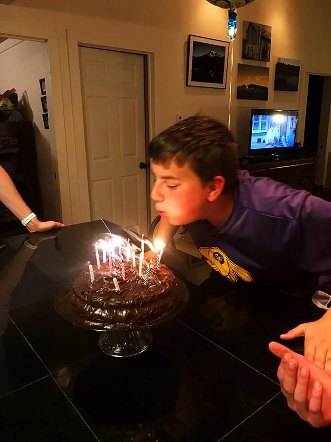 Boy blowing out birthday candles