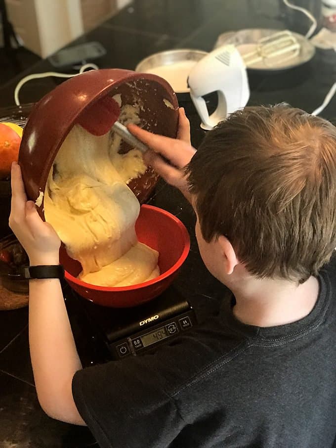 A boy weighing cake batter