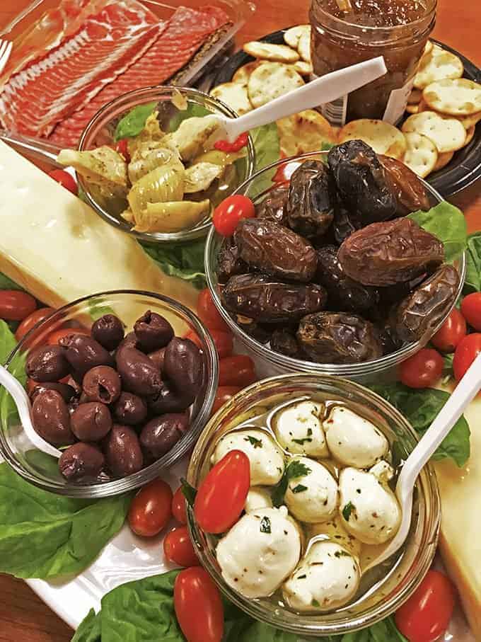 A table topped with different types of antipasto in bowls