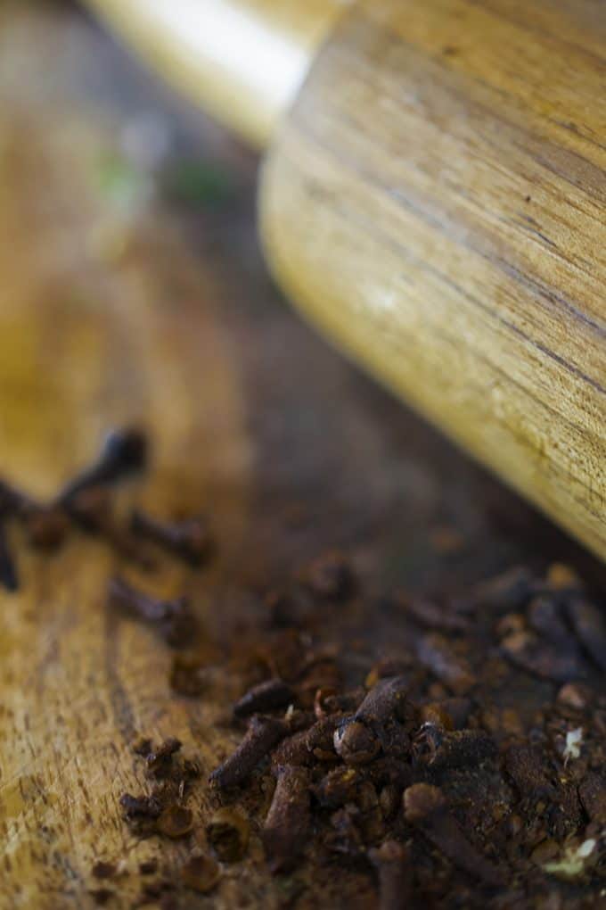 Whole cloves, on wood with rolling pin