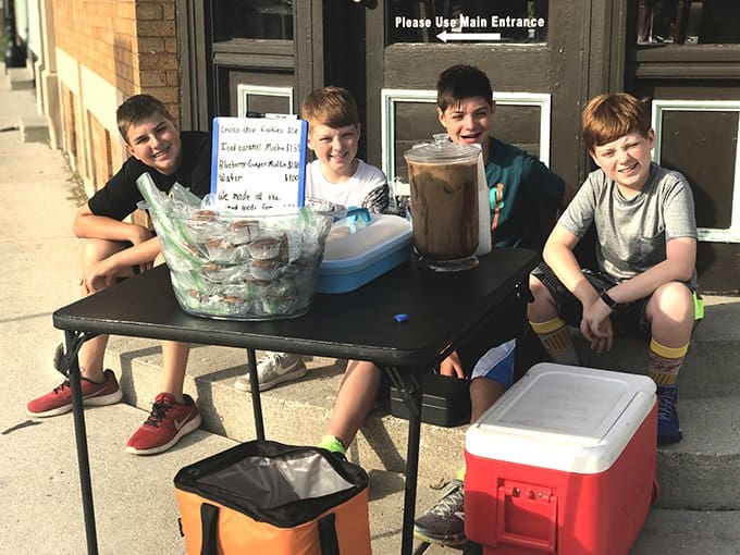 4 kids at table selling cookies