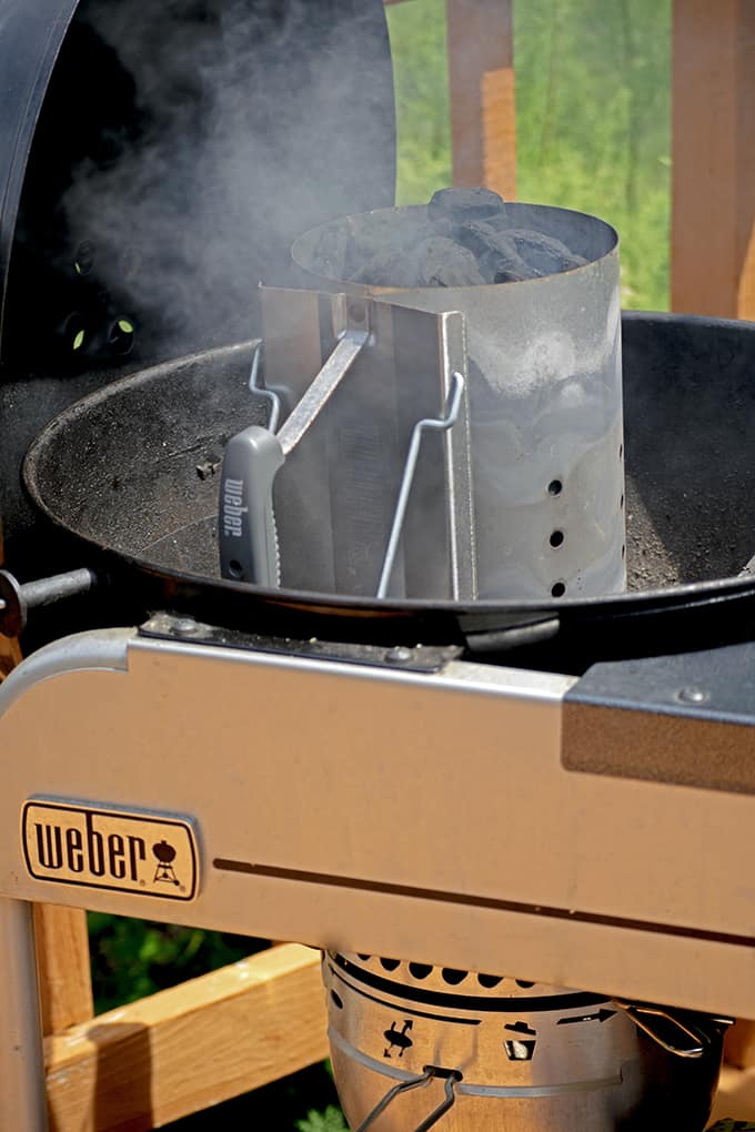 A charcoal chimney is a good way to light charcoal when making jerk chicken.