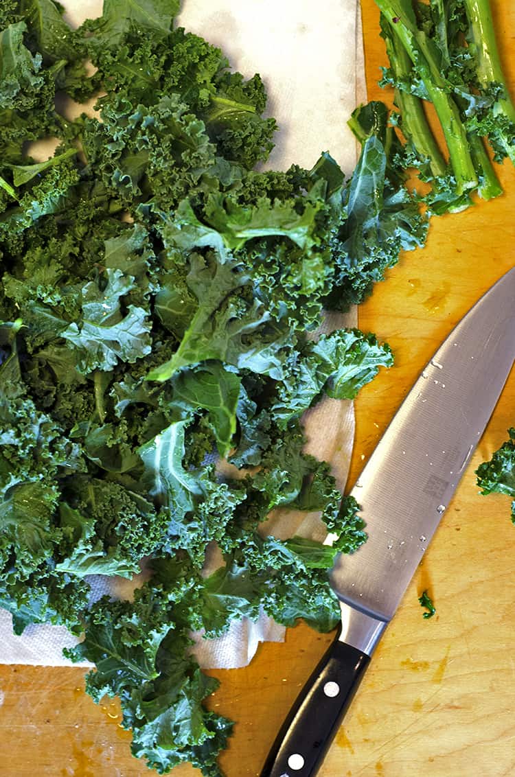 Raw kale chopped with large chef knife.