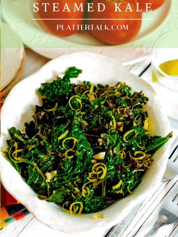 Bowl of steaed kale with lemon zest garnish.