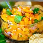 Bowl of papaya salsa with chips.