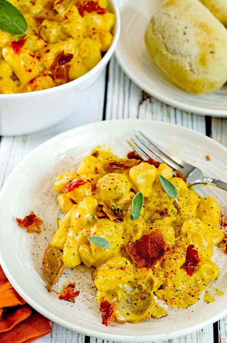 Pumpkin gnocchi a in serving bowl and on plate with fork