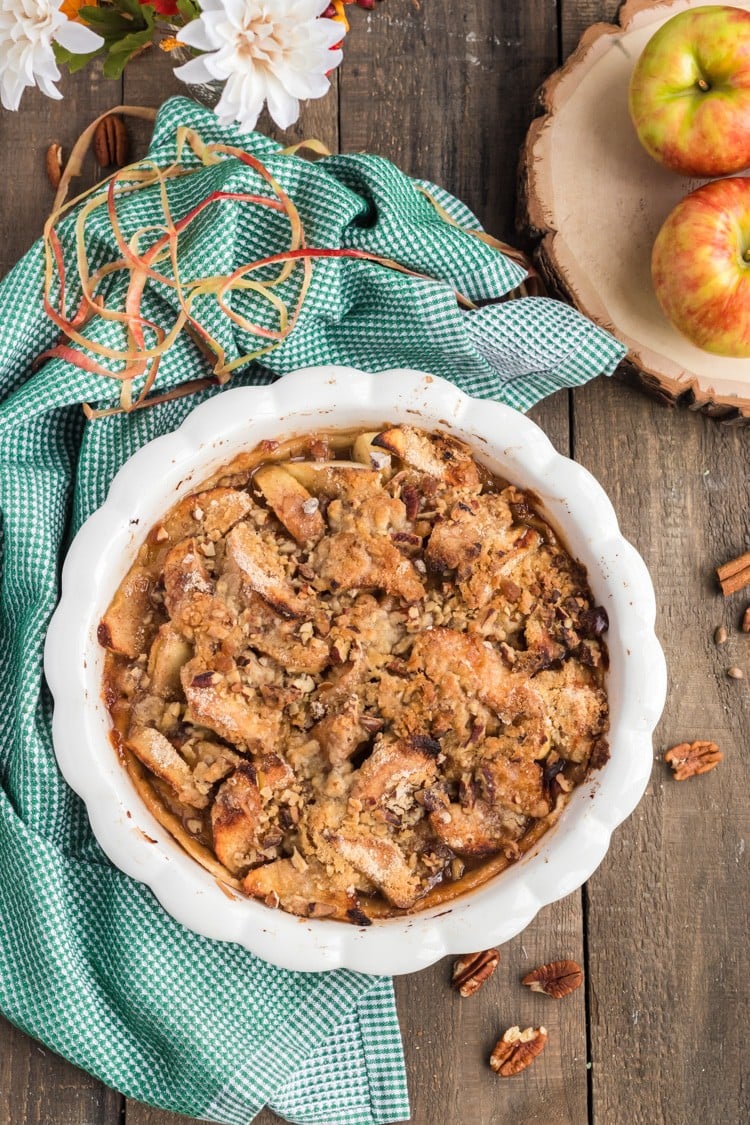 Open face apple pie on a tabletop.