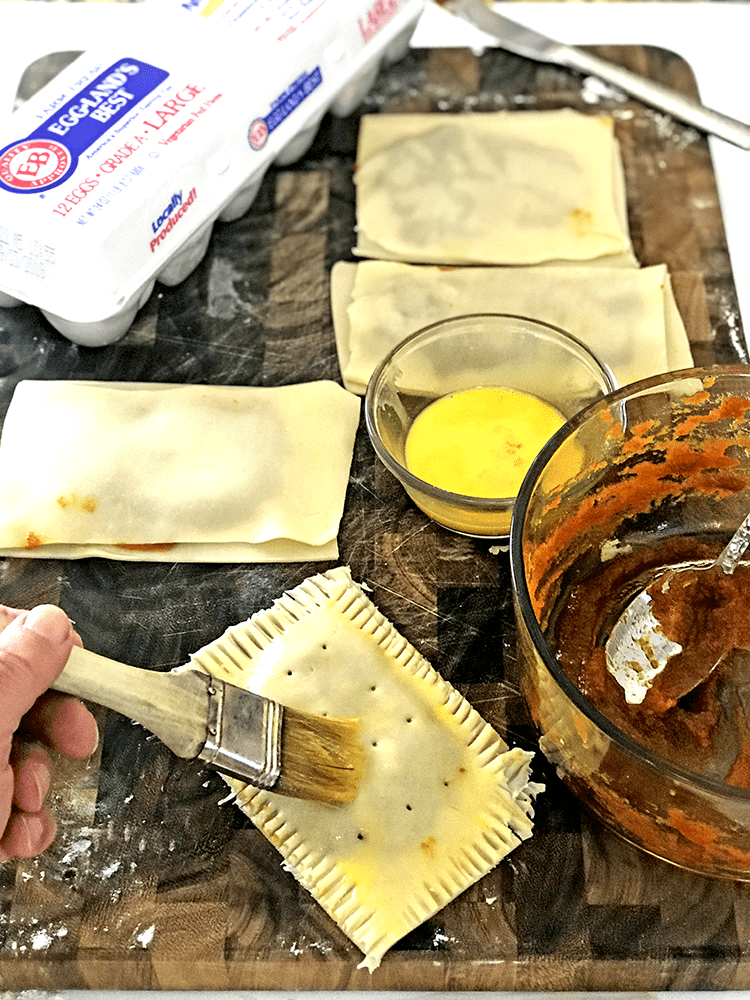 Pop tart, eggs, pastry brush, pumpkin puree in glass bowl