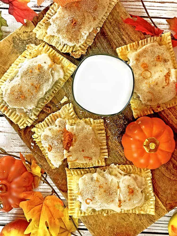 Pop tarts on wooden board with  pumpkin and milk