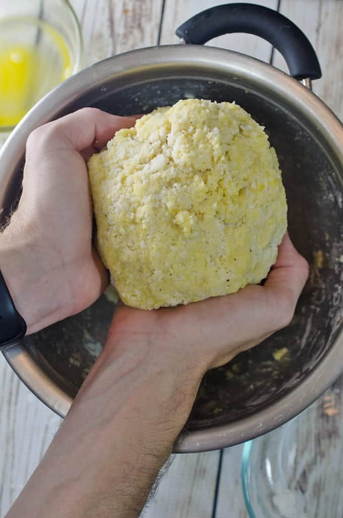Making potato dumplings with potatoes and flour mixture.