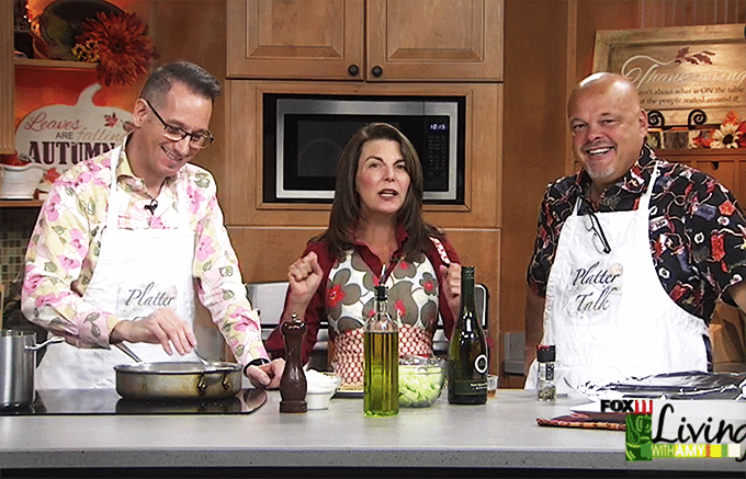 People in kitchen demonstrating cooking and preparation with ingredients at stove and counter