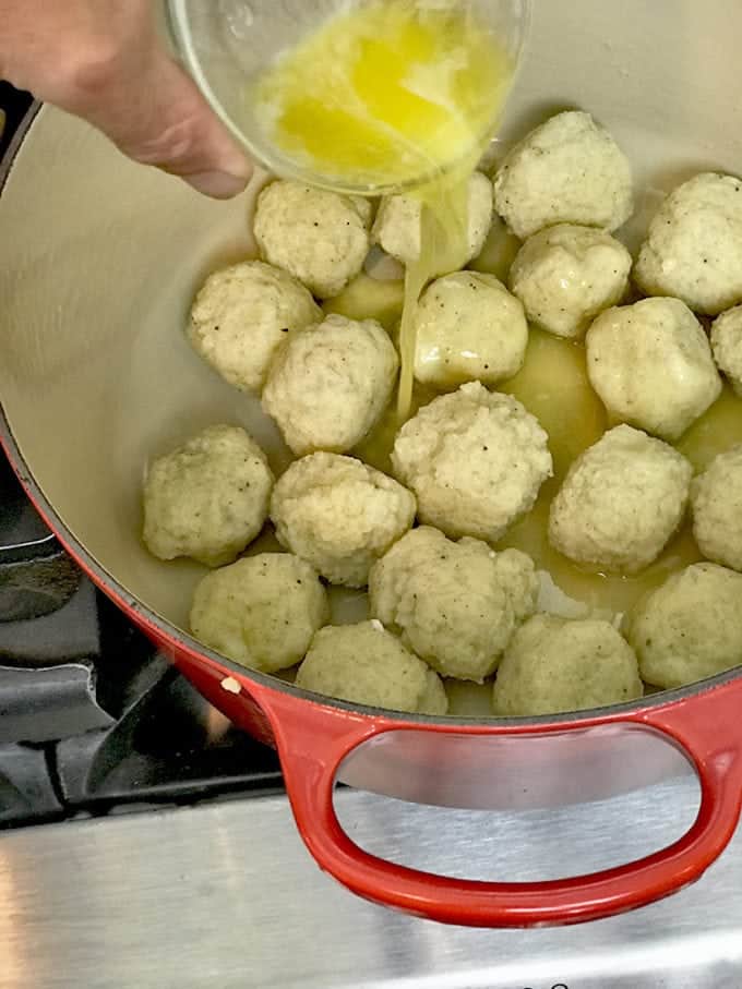 Adding butter to potato dumplings.