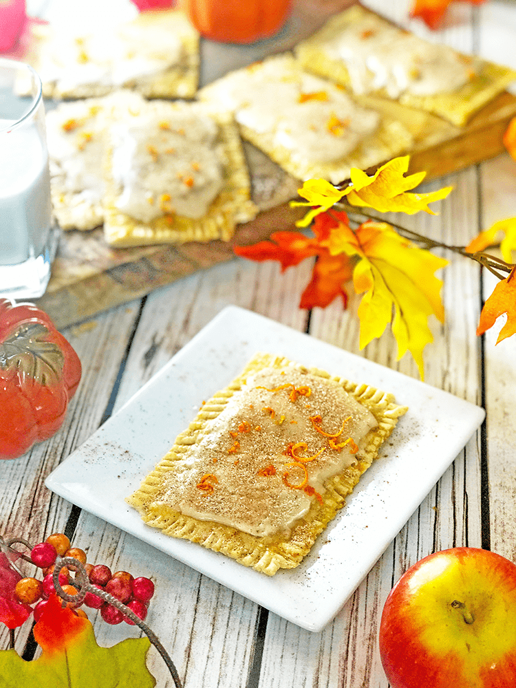 Plate of pop tarts, fall leaves and pop tarts on wood