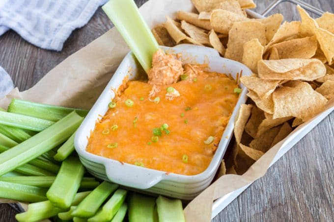 Easy Buffalo chicken dip with celery and tortilla chips.