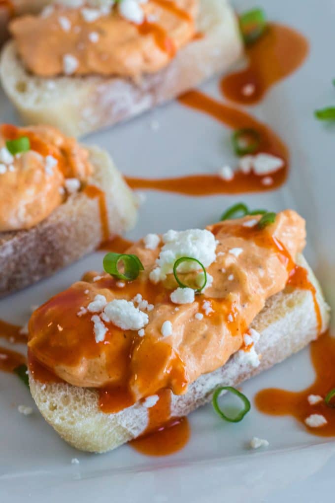 Plate of crostini topped with Buffalo chicken dip