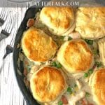 Cast iron skillet holding chicken & bisucits pot pie.