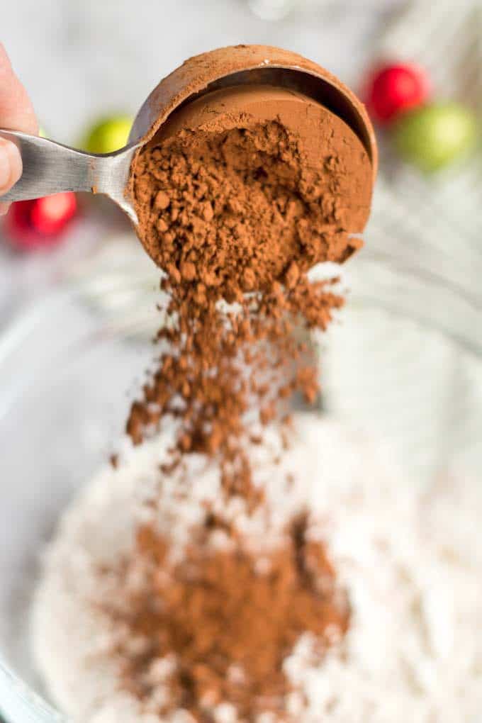 Pouring cocoa powder into a mixing bowl