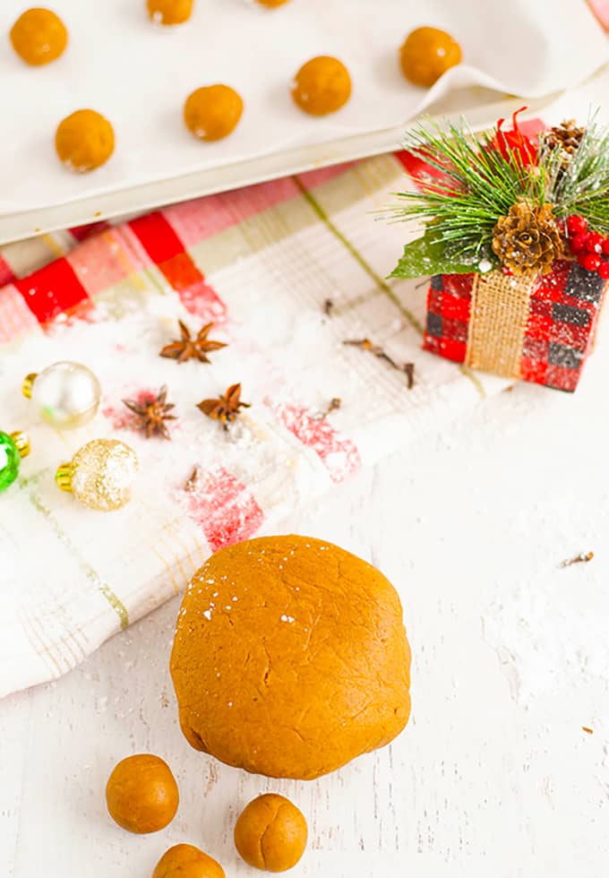 cookies on a baking sheet next to a Christmas gift