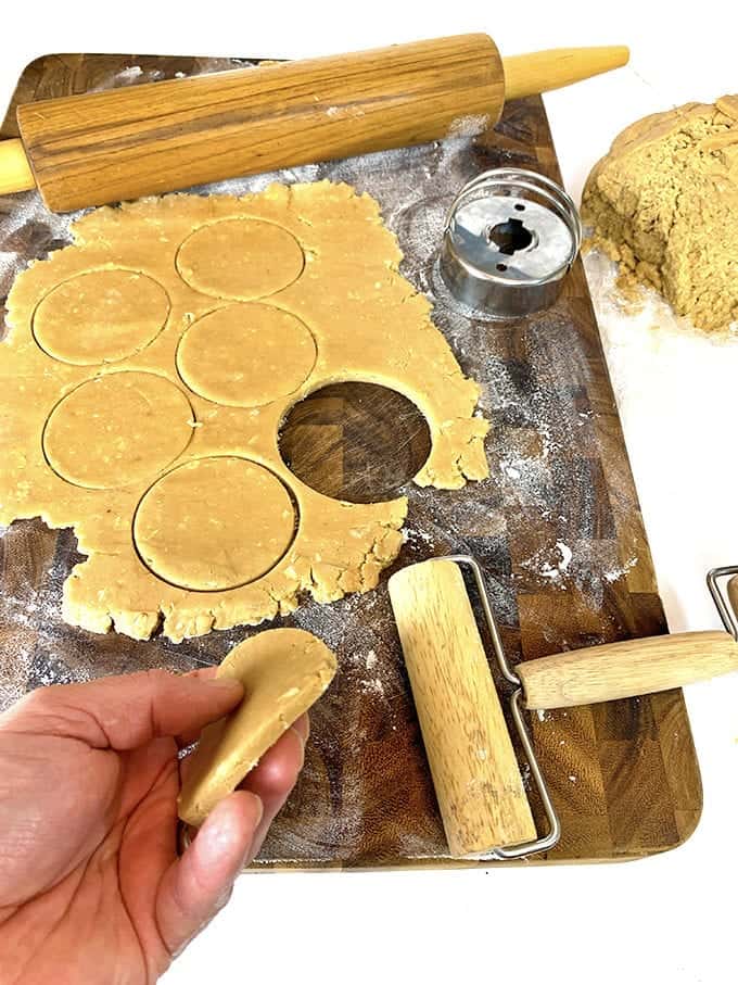 A cutting board with cookie dough