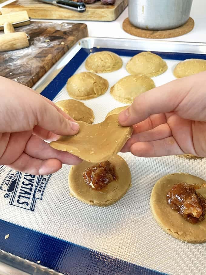 Making date cookies on a baking sheet