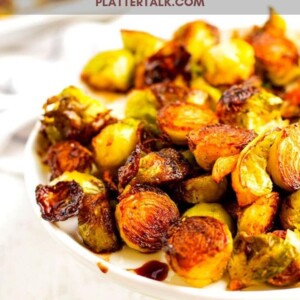 A plate full of food, with Balsamic vinegar and Brussels sprouts