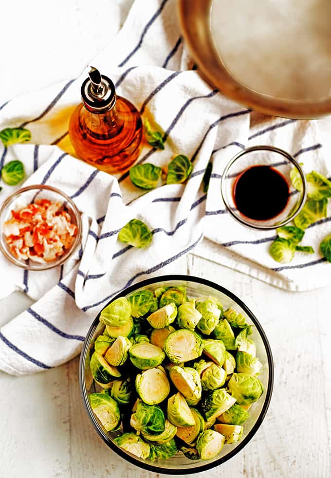 A bowl of raw Brussels sprouts and other ingredients