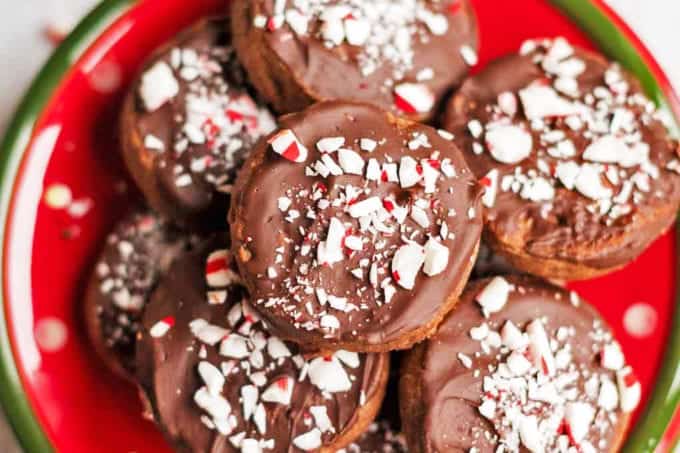 A close up of a plate cookies covered with chocolate