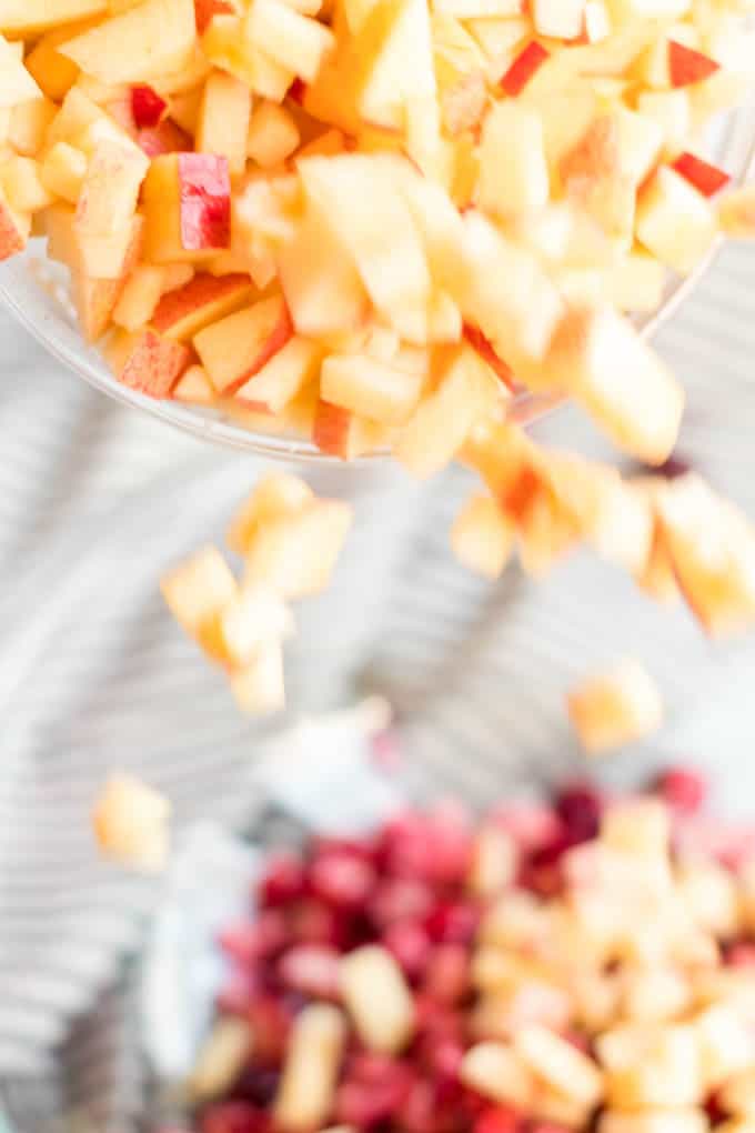 chopped apple pieces being used in cranberry salad.