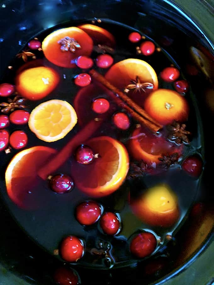A crockpot of fruit, with mulled Sangria