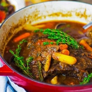 A Dutch oven with braised beef in it.
