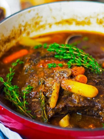 A Dutch oven with braised beef in it.