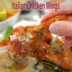 dipping an Italian chicken wing in sauce.