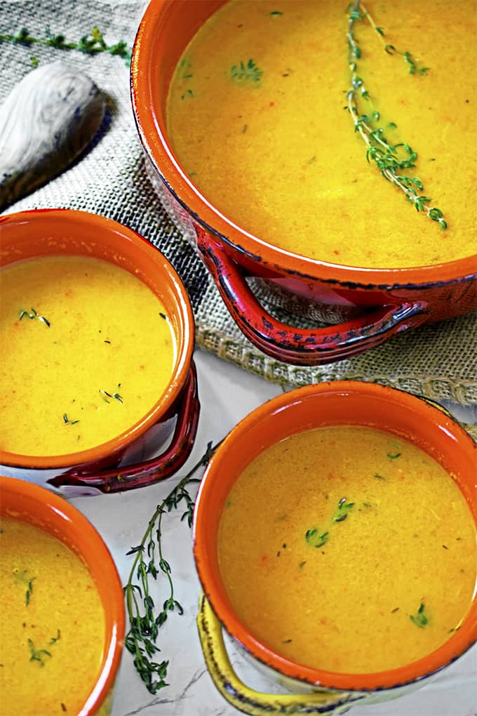 Four bowls of roasted butternut squash soup.