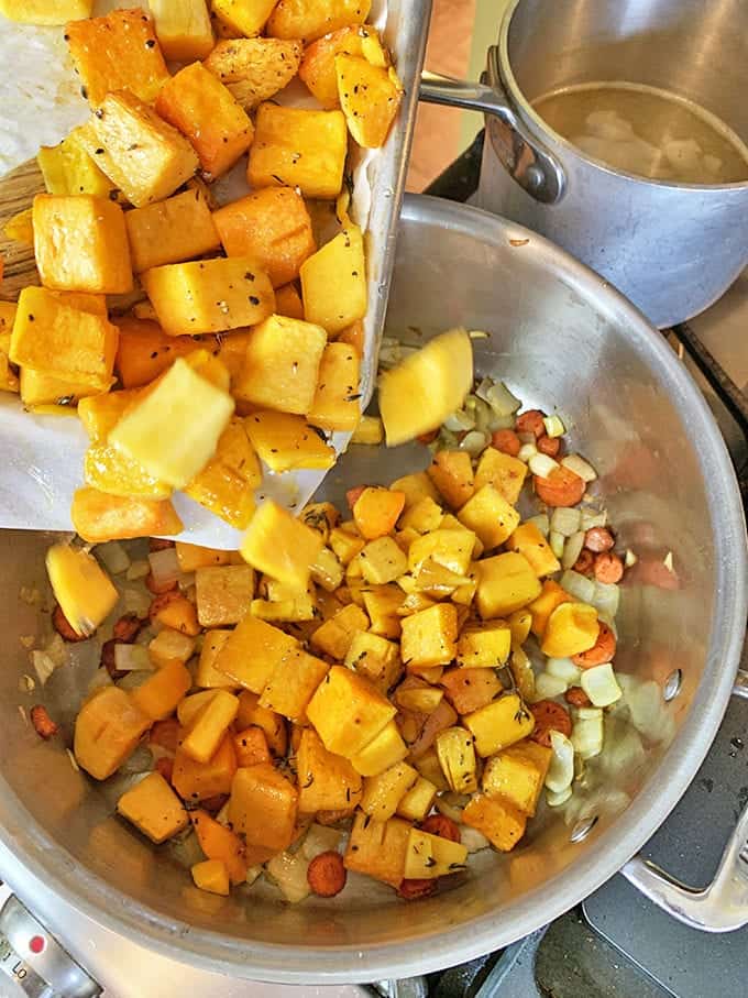 Adding roasted butterrnut squash to a mirepoix.