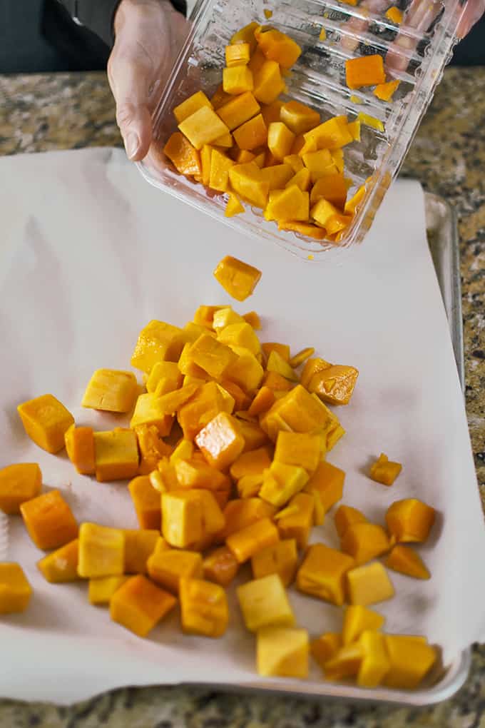 Cubes of butternut squash on a cutting board